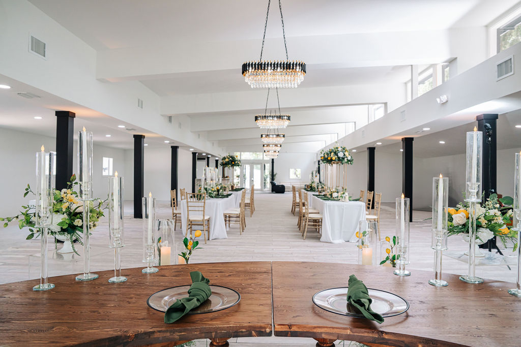 Elegant white event venue with modern decor and floral centerpieces