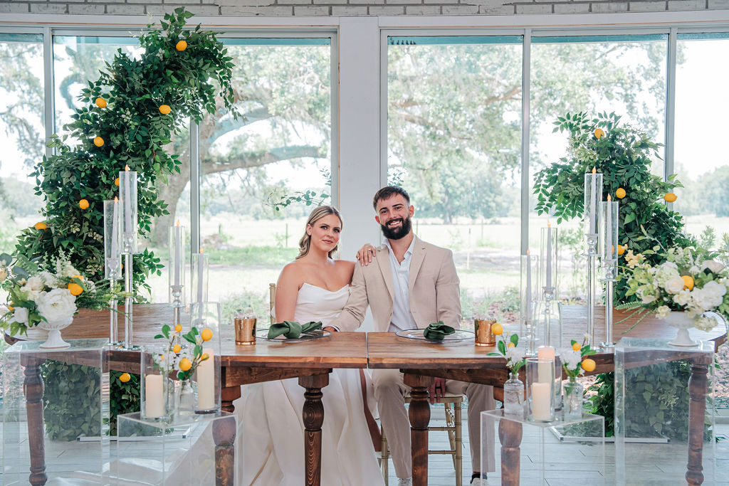 Bright portrait of a bride and groom at their wedding reception table